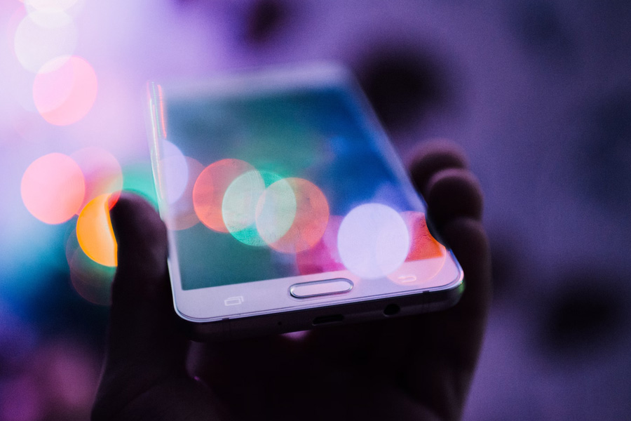 A digital forensic expert holding a smartphone